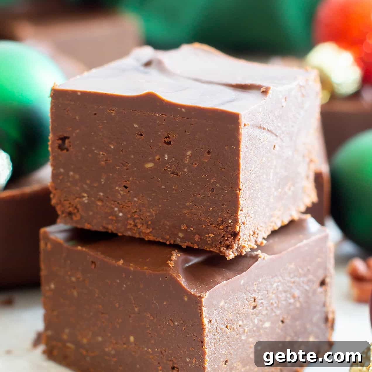 two pieces of keto fudge in a stack with ornaments