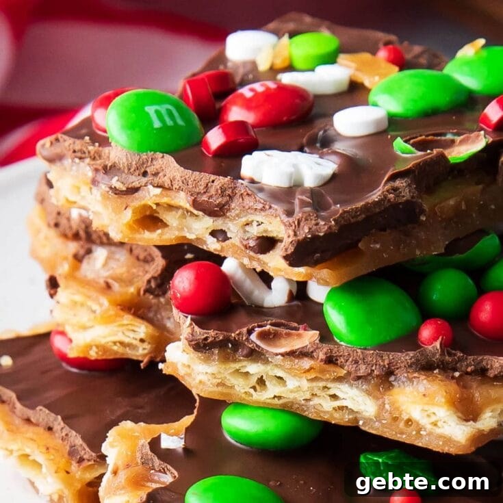 Stack of Christmas Crack on a plate featuring red and green Christmas M&M's