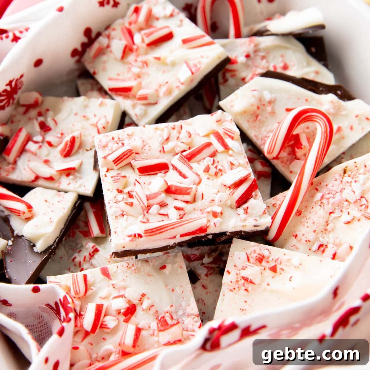 Cascades of peppermint bark pieces in a candy dish with mini candy canes