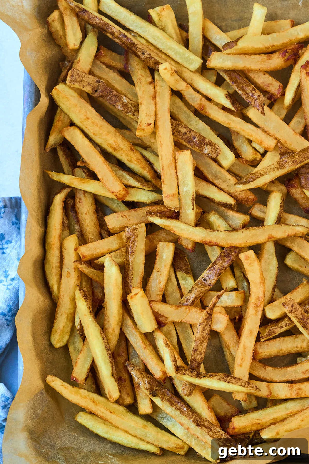 Crispy Deep-Fried French Fries: Step-by-Step Recipe Guide 2 tray of french fries on piece of parchment.