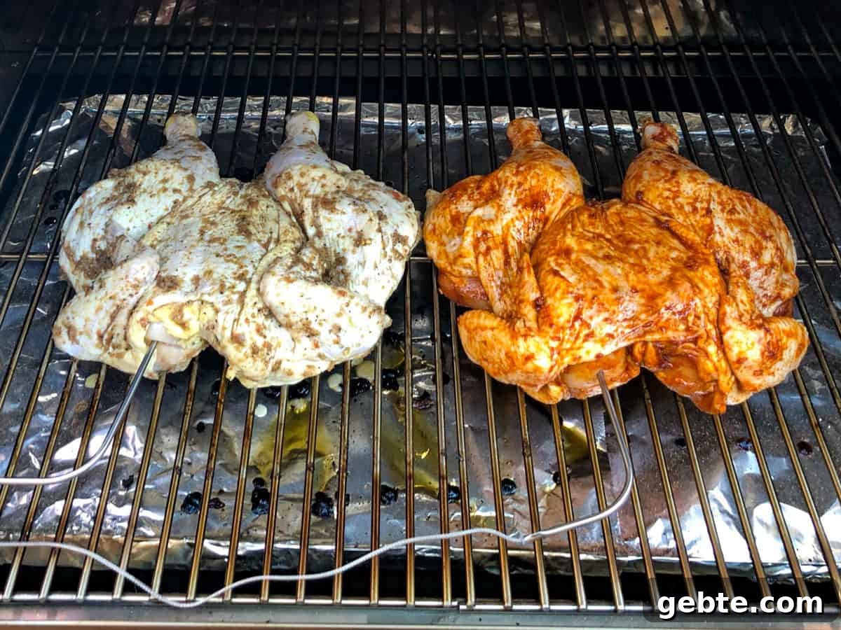 Two chickens on grill with meat probes inserted into breast