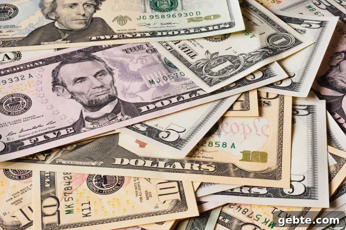 Several different sized US money bills on table