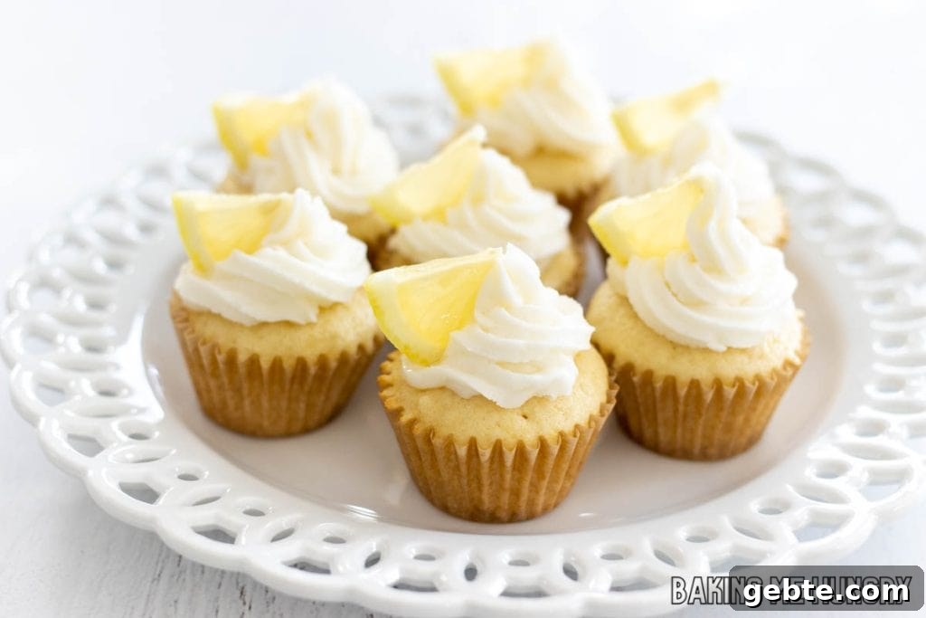 mini lemon cupcakes on decorative white plate from side