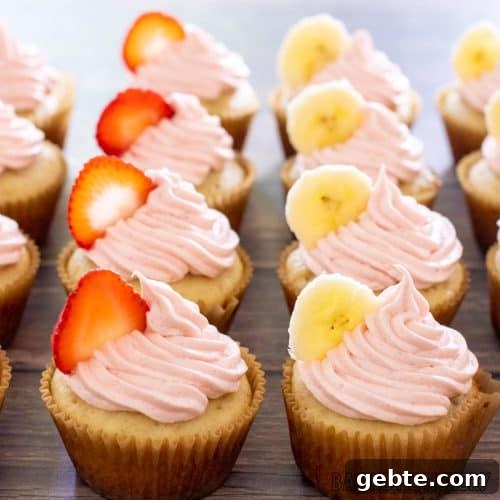 strawberry banana cupcakes topped with slices of fruit