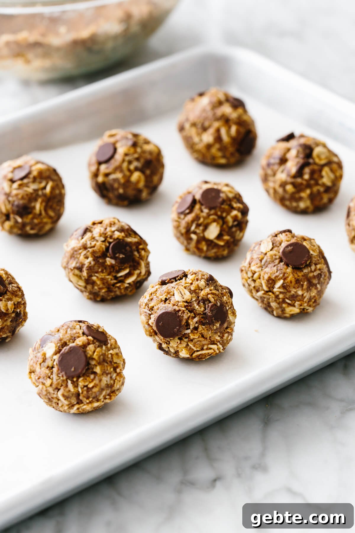 No bake chocolate chip energy balls on a sheet pan.