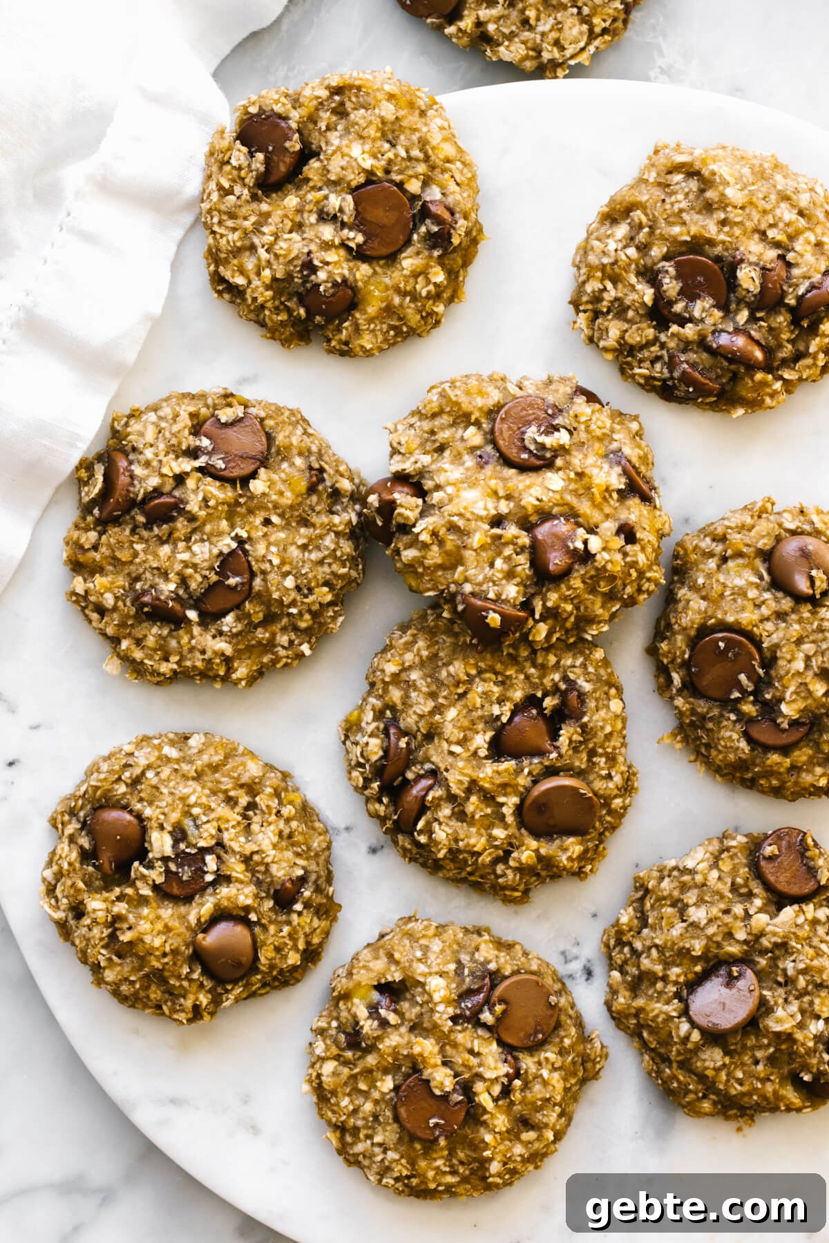 Banana oatmeal cookies laid out on a marble plate.