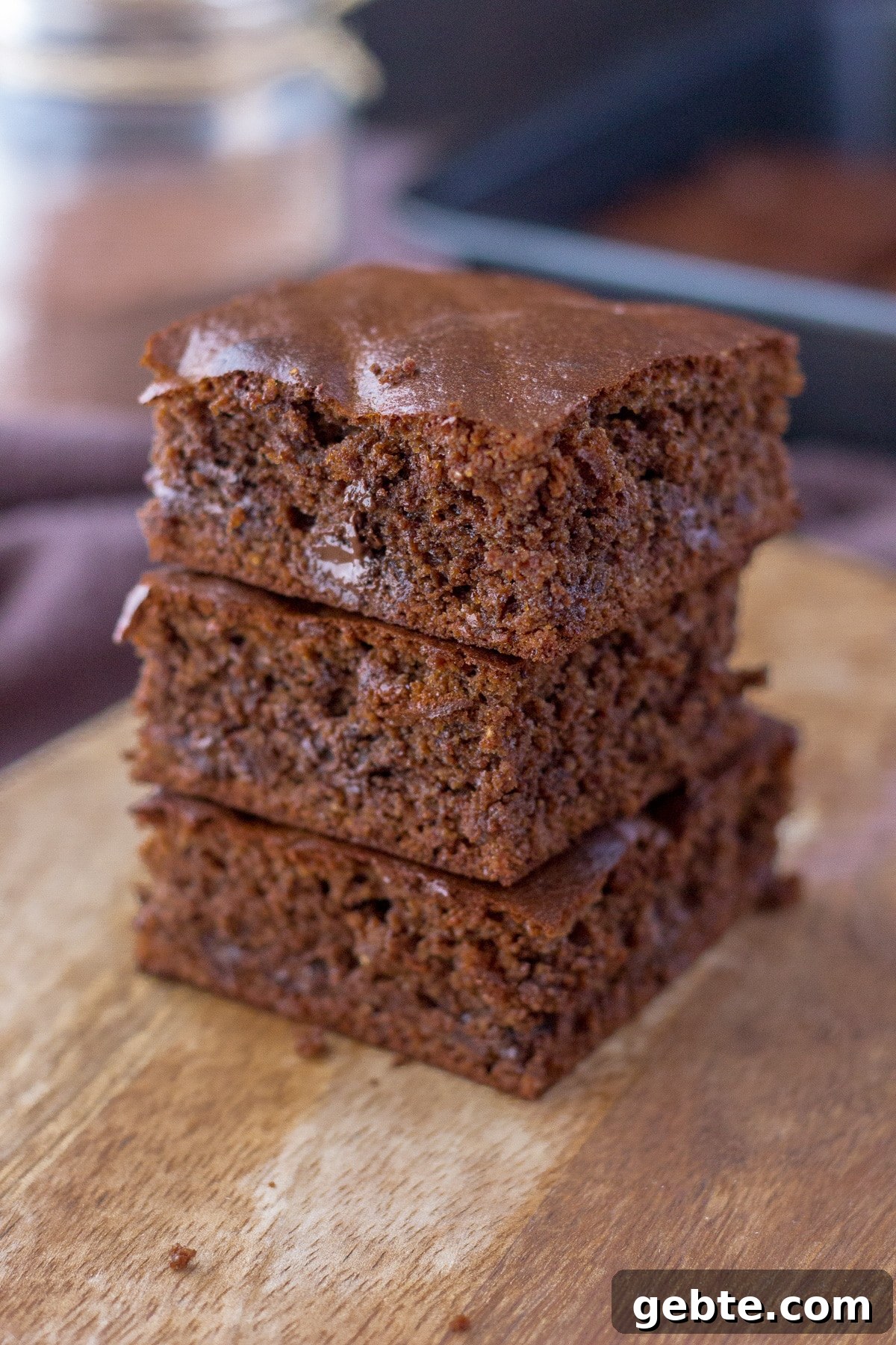 Almond butter brownies sliced and served on a wooden plate