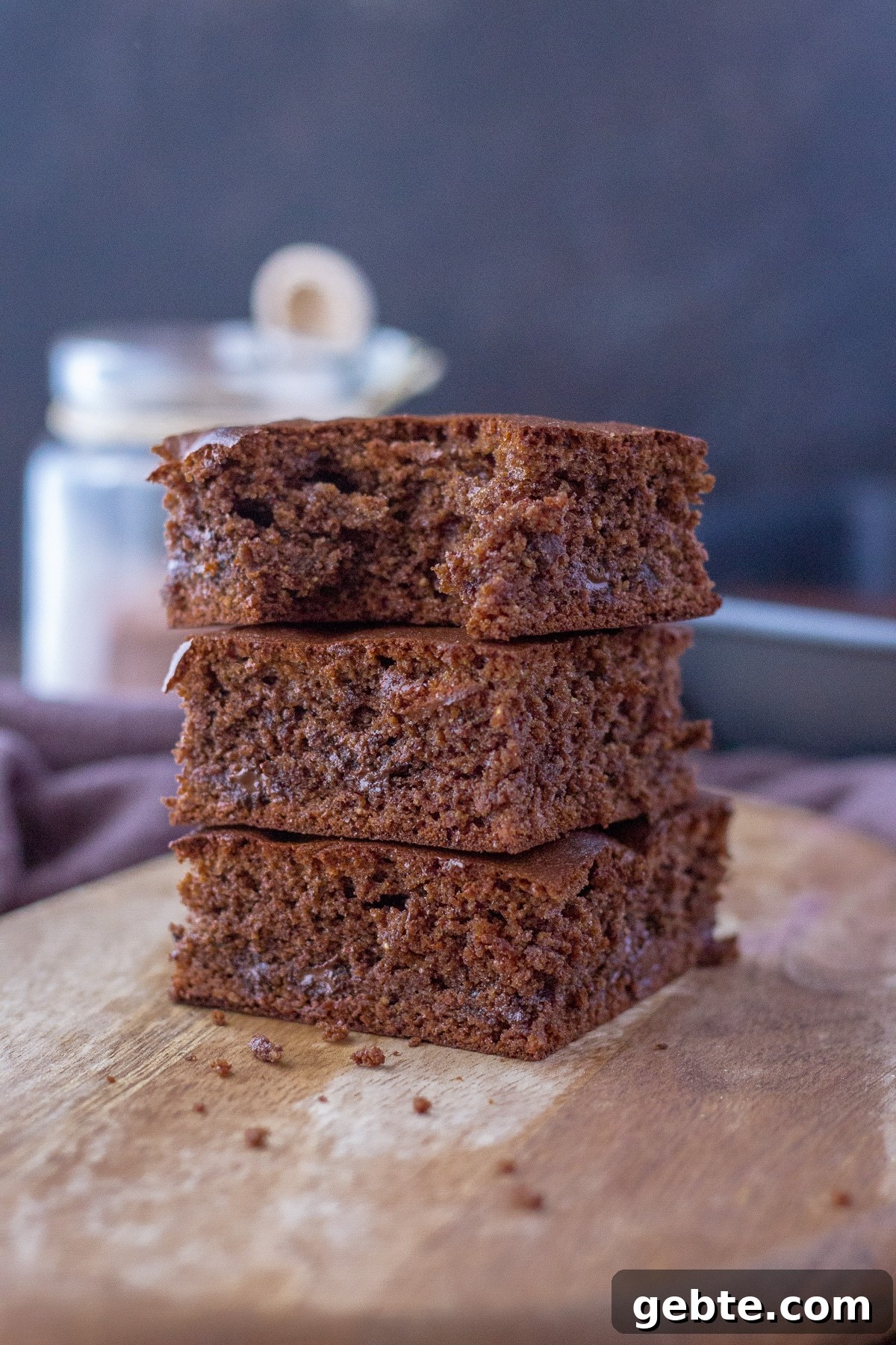 Almond butter brownies sliced and served on a wooden plate