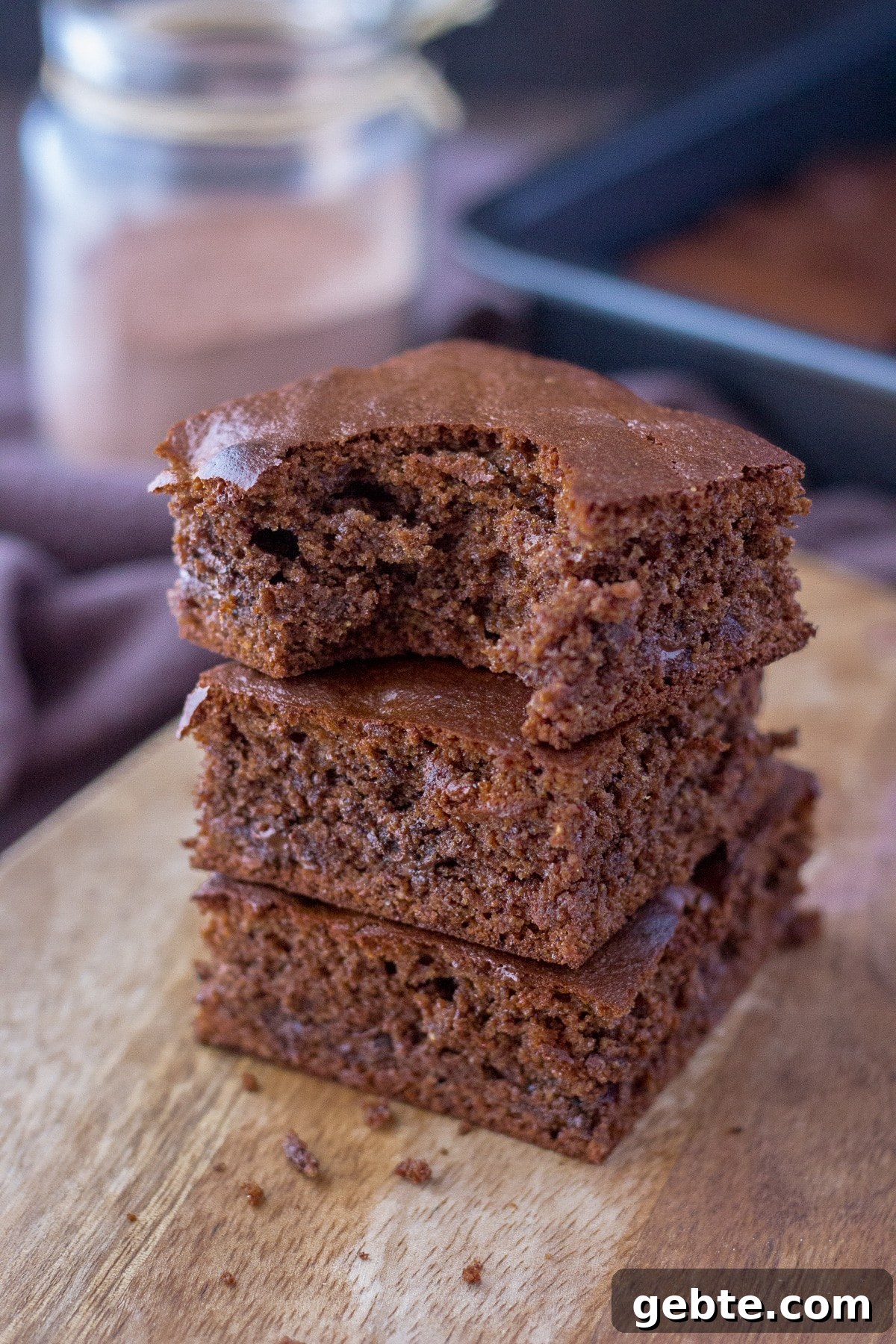 Almond butter brownies sliced and served on a wooden plate
