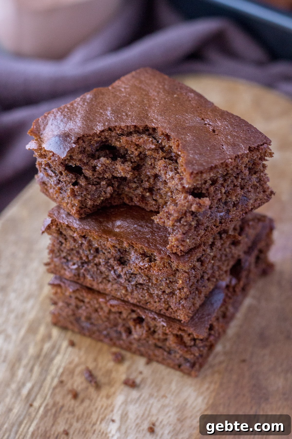 Almond butter brownies sliced and served on a wooden plate
