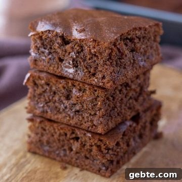 Almond butter brownies sliced and served on a wooden plate