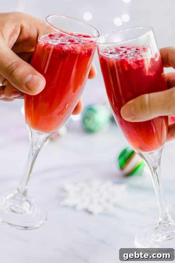 Sparkling Christmas Mimosa Recipe: Festive Holiday Brunch Cocktail 2 Christmas Mimosas! Celebrate Christmas morning with a mimosa that has a combination of orange juice and pomegranate juice!
