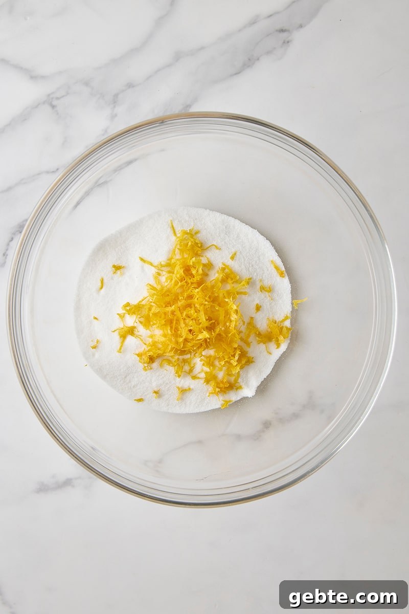 Granulated sugar and lemon zest in glass bowl