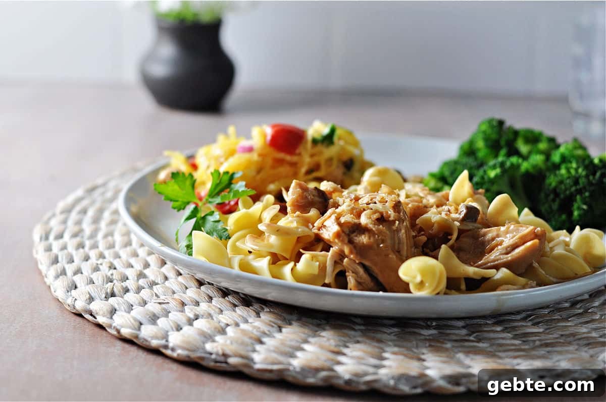 Instant pot French onion chicken served on noodles.