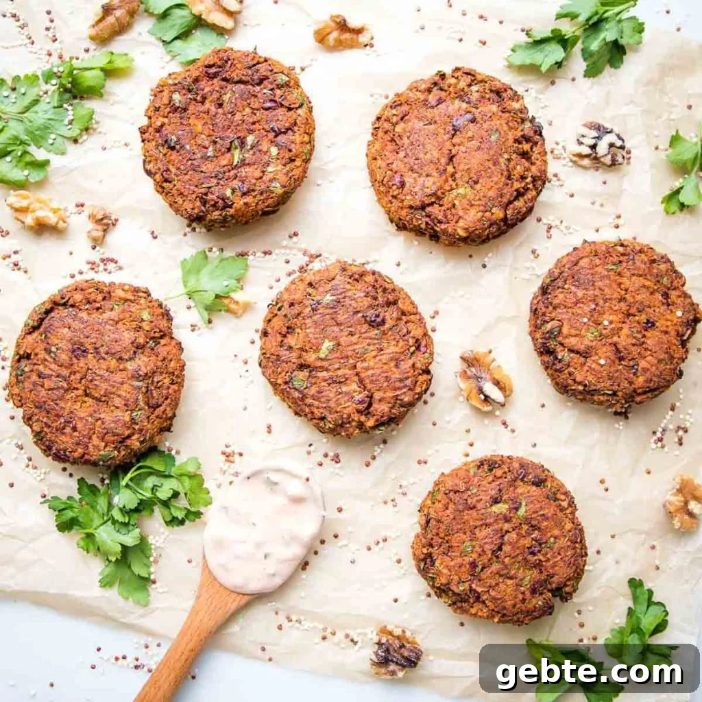 Veggie burger patties spread out, surrounded by walnuts and fresh herbs.