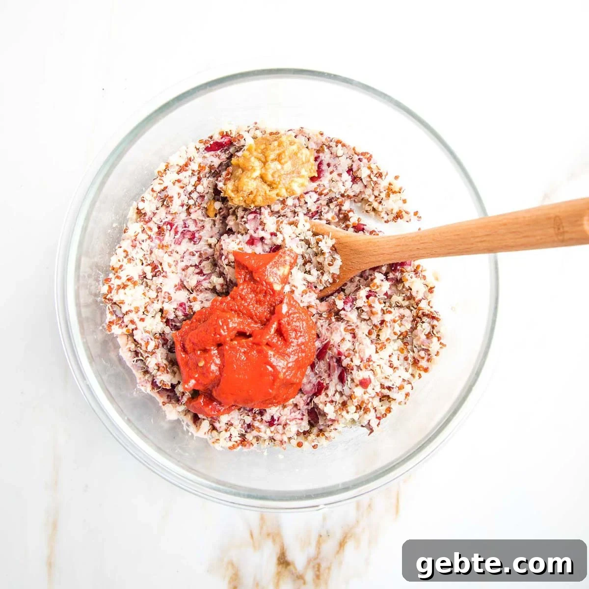 Tomato paste and miso paste on top of a mixture of quinoa and mashed beans.