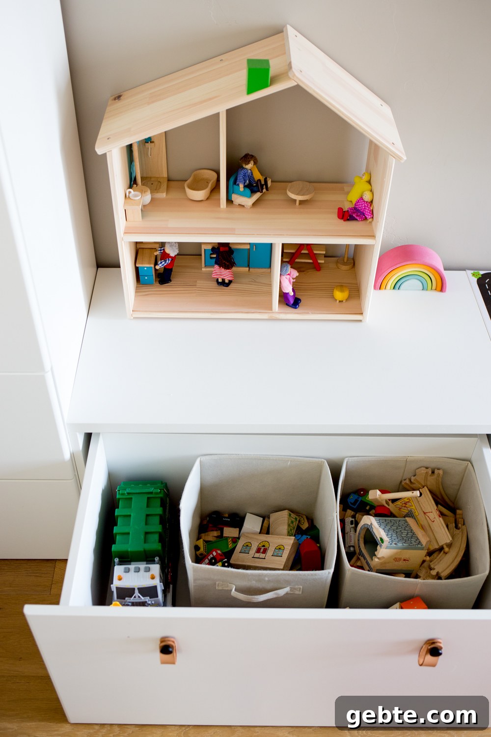 Declutter Toys Quickly: Smart Steps to Organize Kids’ Playroom 5 white modern toy storage bench IKEA with toys in open drawer and simple wooden dollhouse on top
