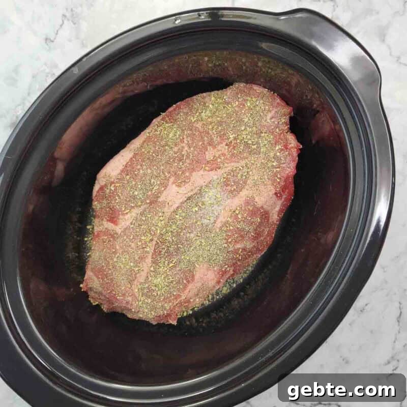Place the roast in the slow cooker and season it with the salt, pepper, and italian seasoning.