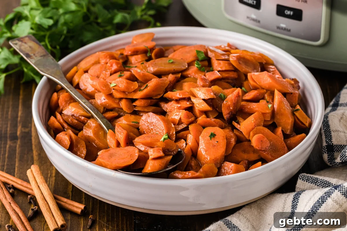 A white bowl with brown sugar carrots and a spoon.