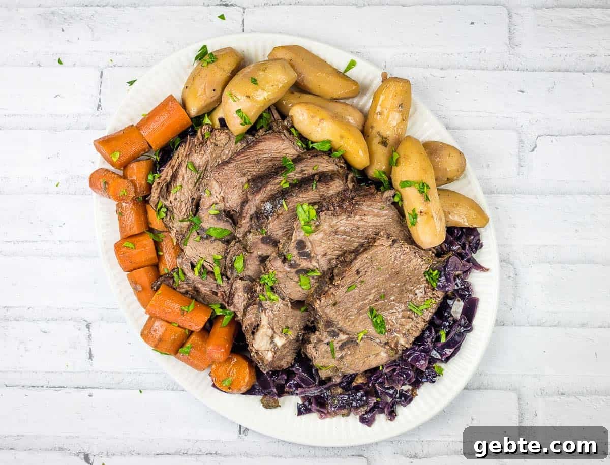 31 Slow Cooker Recipes to Walk In and Find Dinner Waiting 15 A plate of German pot roast beef with a sauce being poured over it.