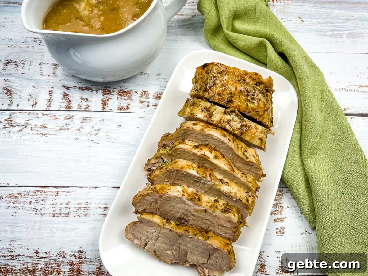 31 Slow Cooker Recipes to Walk In and Find Dinner Waiting 17 German Pork Loin on a platter with a gravy boat nearby.