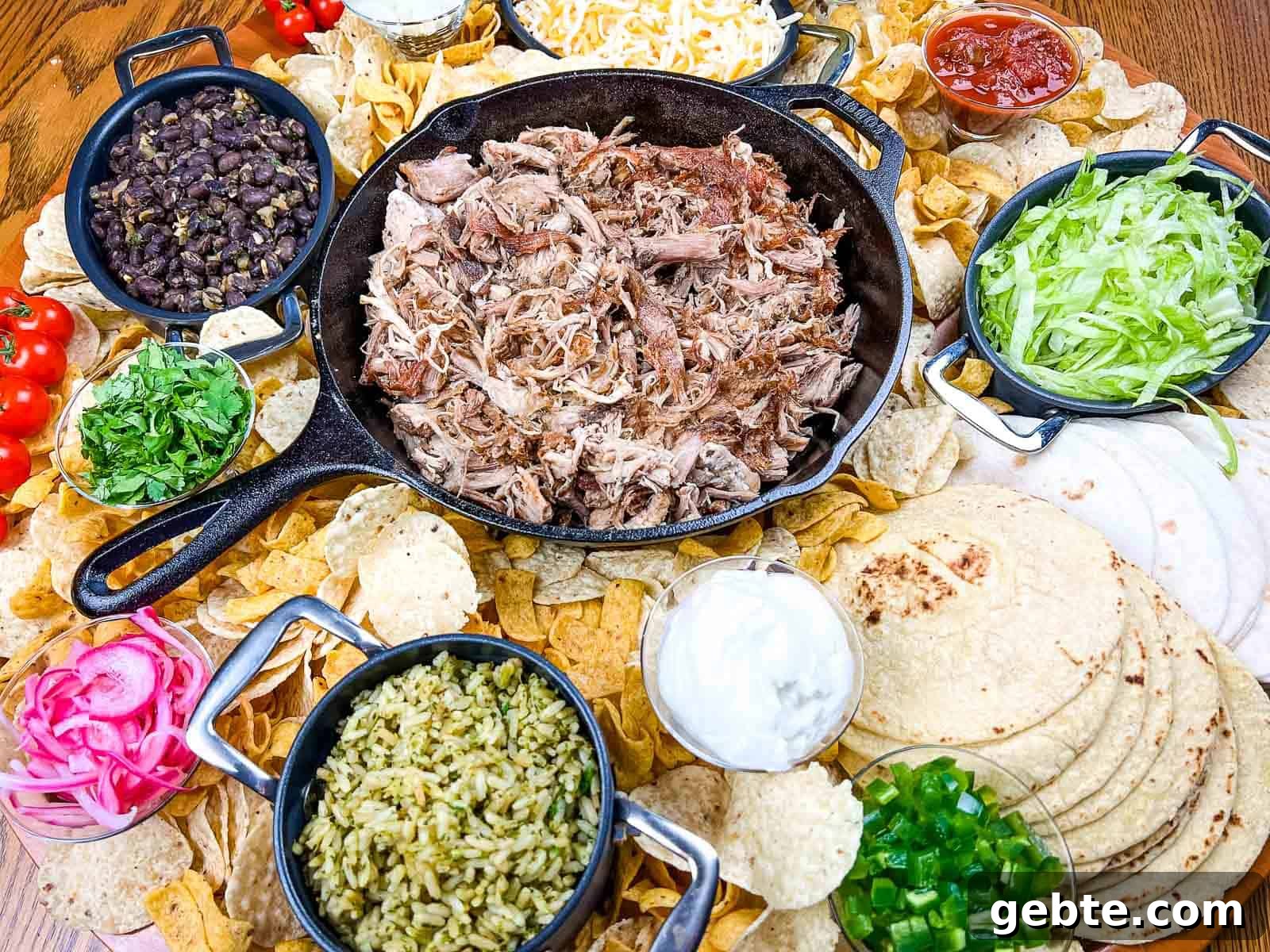 31 Slow Cooker Recipes to Walk In and Find Dinner Waiting 20 A platter of pork carnitas board on a wooden table.