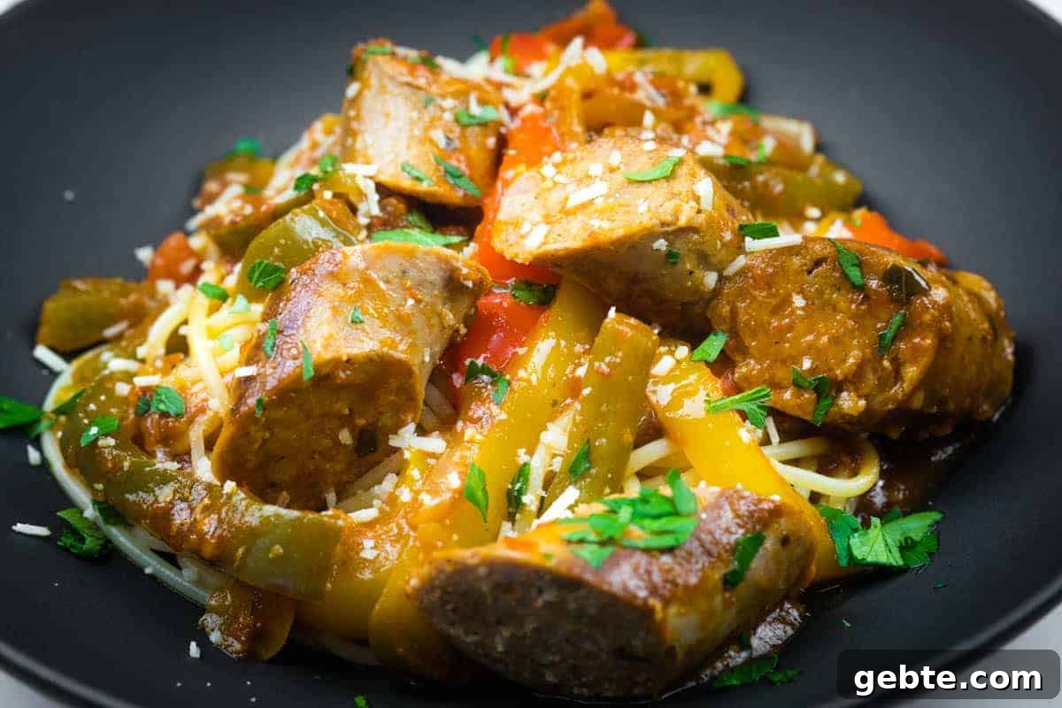 31 Slow Cooker Recipes to Walk In and Find Dinner Waiting 21 Slow cooker sausage and peppers garnished with grated cheese and chopped parsley.