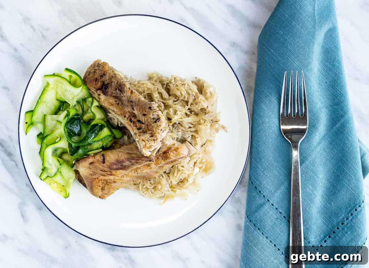 31 Slow Cooker Recipes to Walk In and Find Dinner Waiting 23 Ribs and Sauerkraut with a fork.