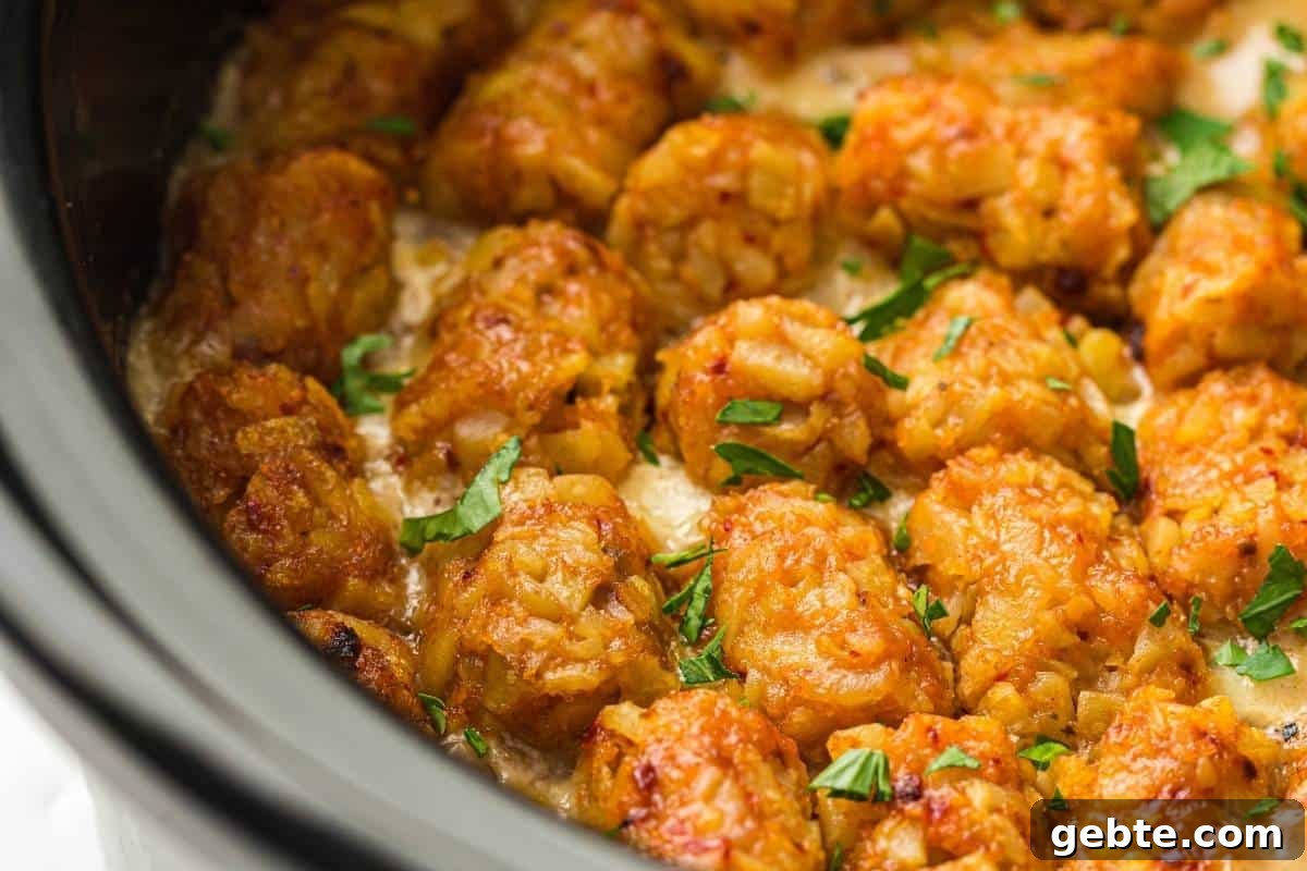 31 Slow Cooker Recipes to Walk In and Find Dinner Waiting 31 Close-up of Slow Cooker Cowboy Casserole garnished with chopped parsley, inside a slow cooker.