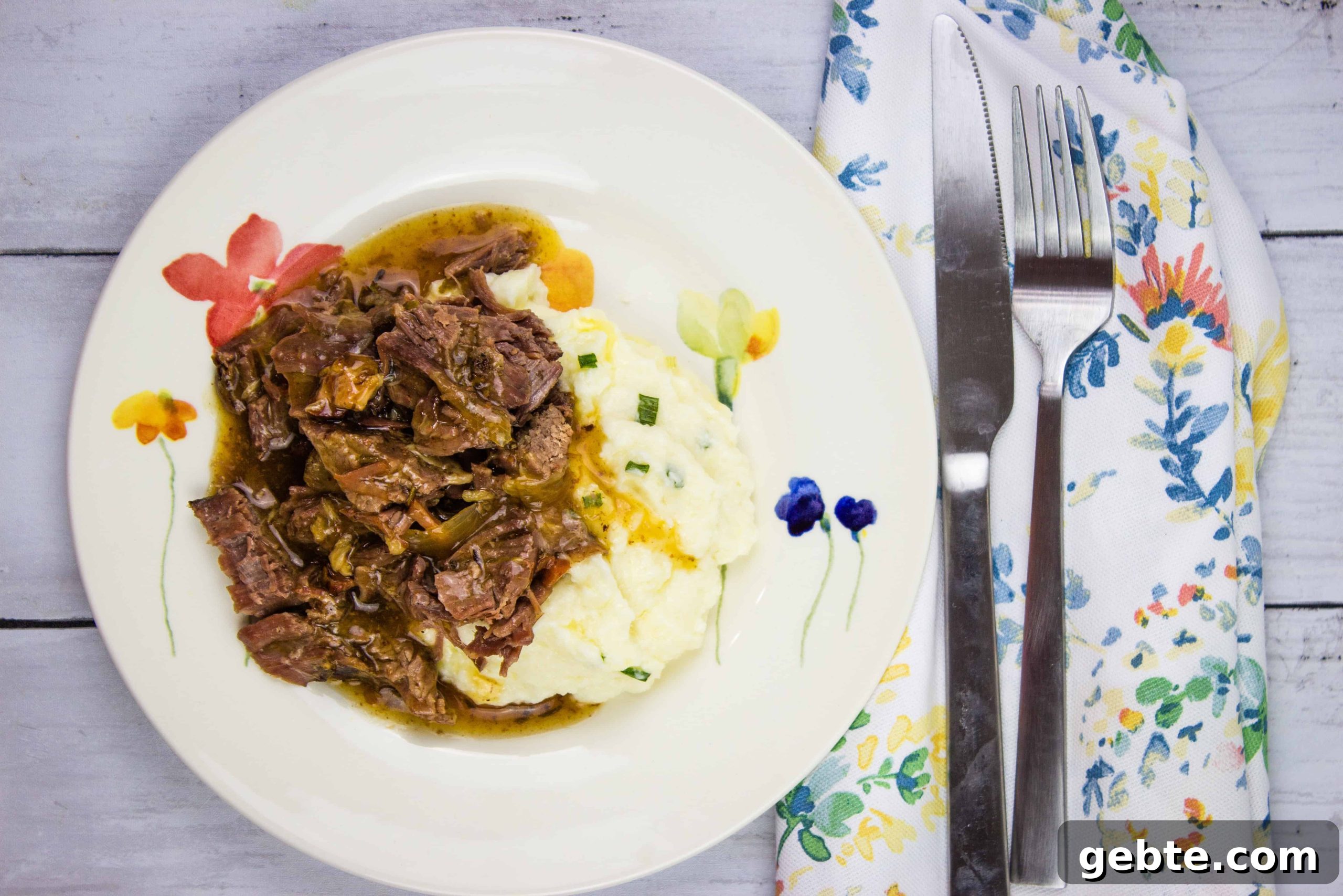 31 Slow Cooker Recipes to Walk In and Find Dinner Waiting 33 A plate of pot roast with bacon and mashed potatoes with gravy.