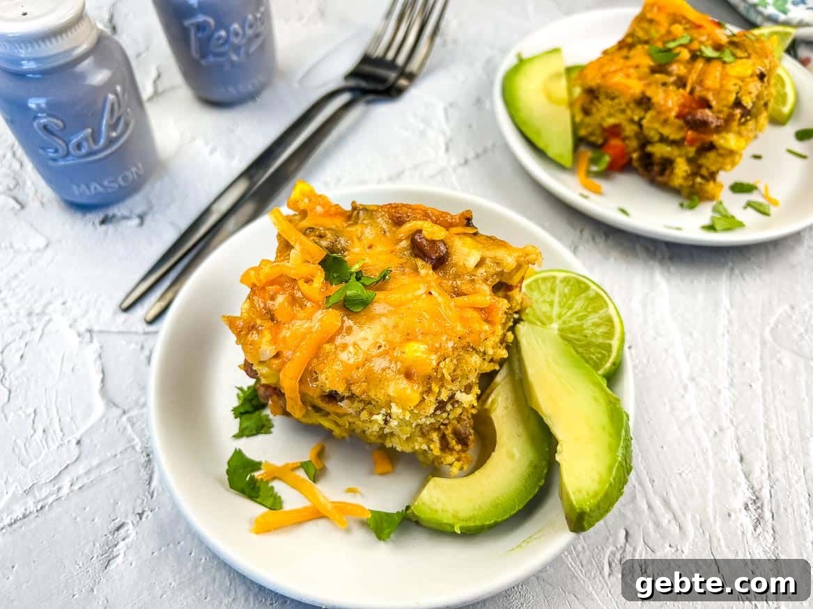 31 Slow Cooker Recipes to Walk In and Find Dinner Waiting 10 Two servings of Cowboy Cornbread Casserole on plates.