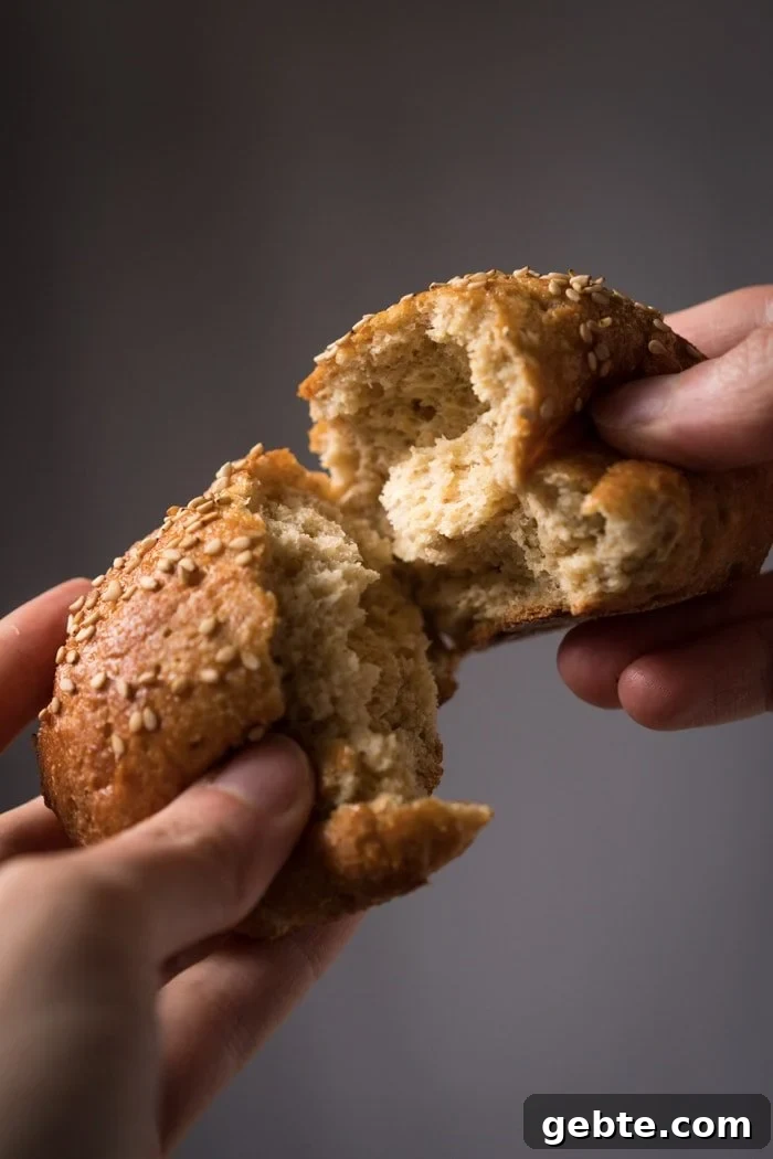 Keto Hot Dogs with Fluffy Yeast Buns: Low-Carb Recipe 3 Splitting in half a pillowy soft Keto burger bun with sesame seeds