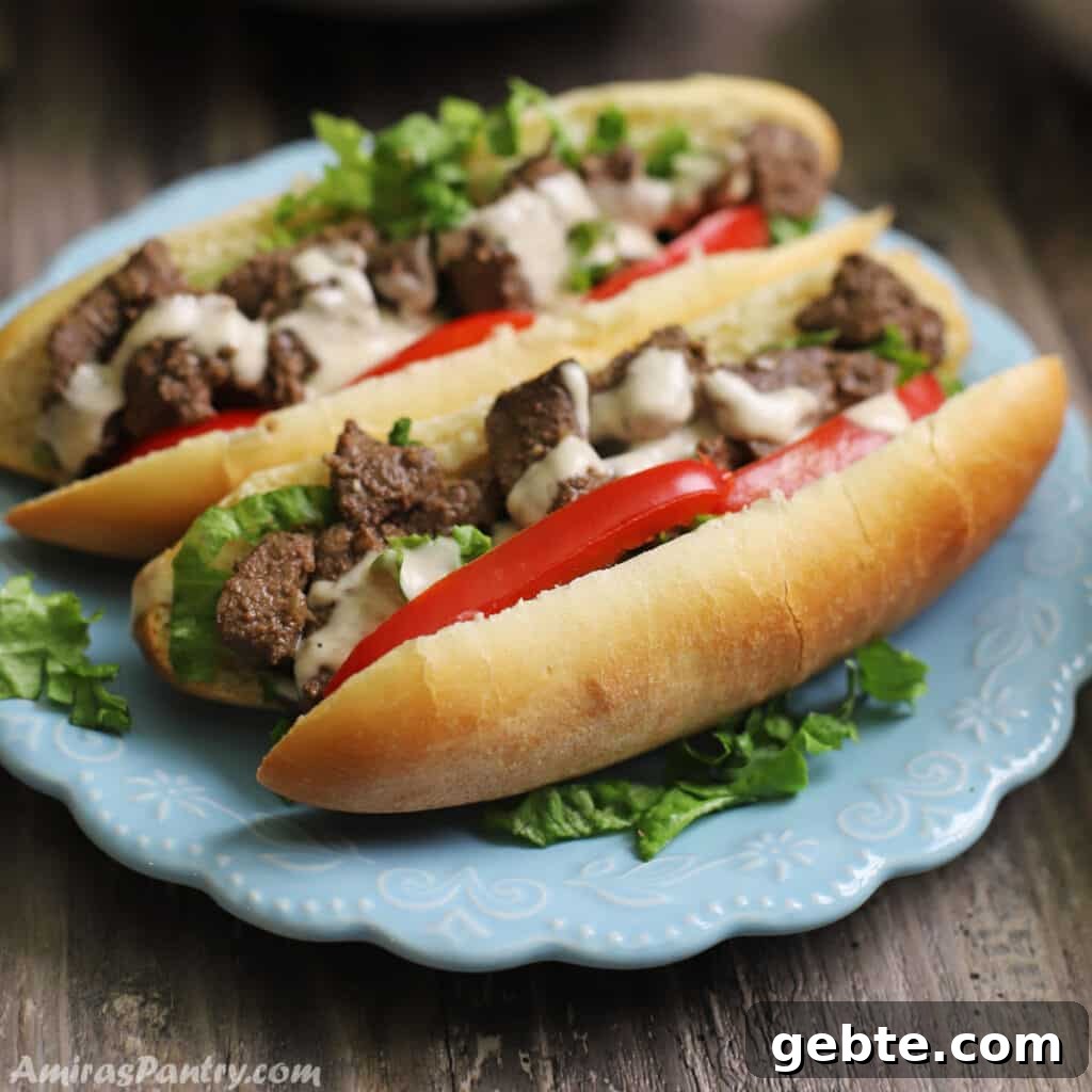 Two liver sandwiches on a blue plate and garnished with lettuce and tahini sauce.