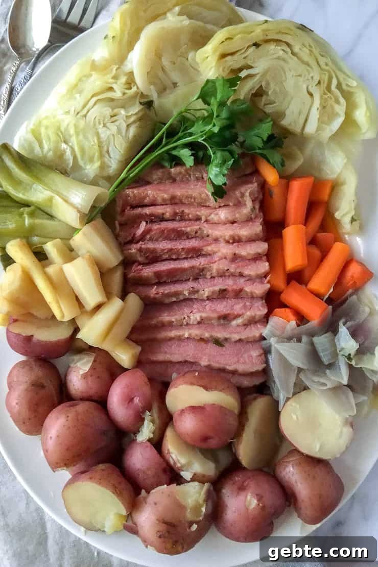 Corned Beef and Cabbage, on serving platter, sliced corned beef surrounded by cabbage and vegetables.