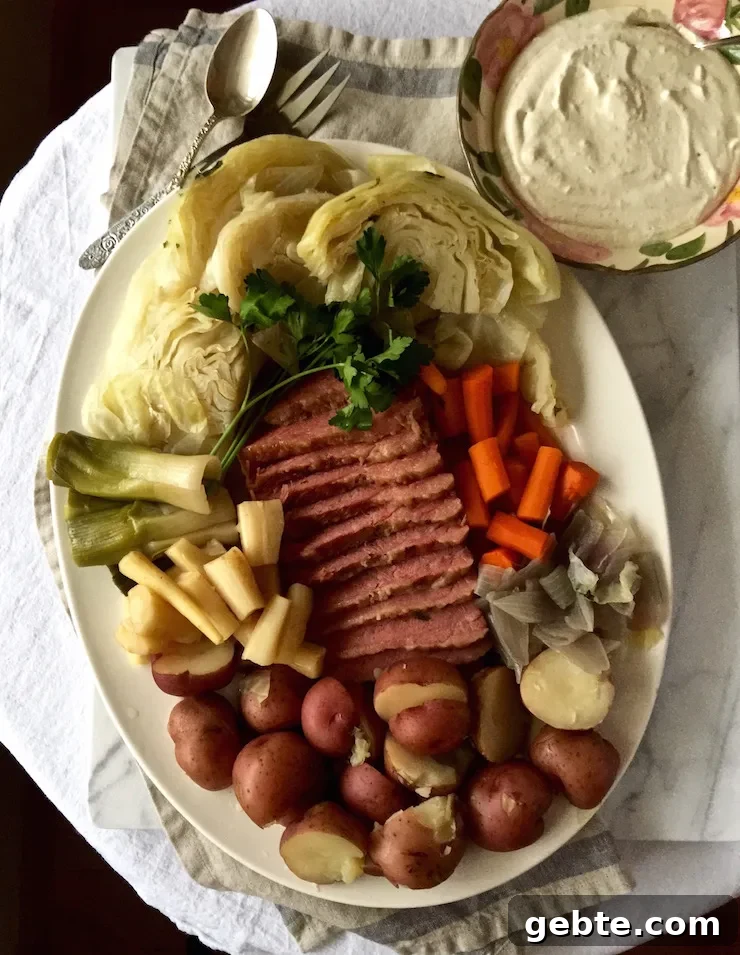Corned Beef and Cabbage, on serving platter with bowl of horseradish cream sauce.