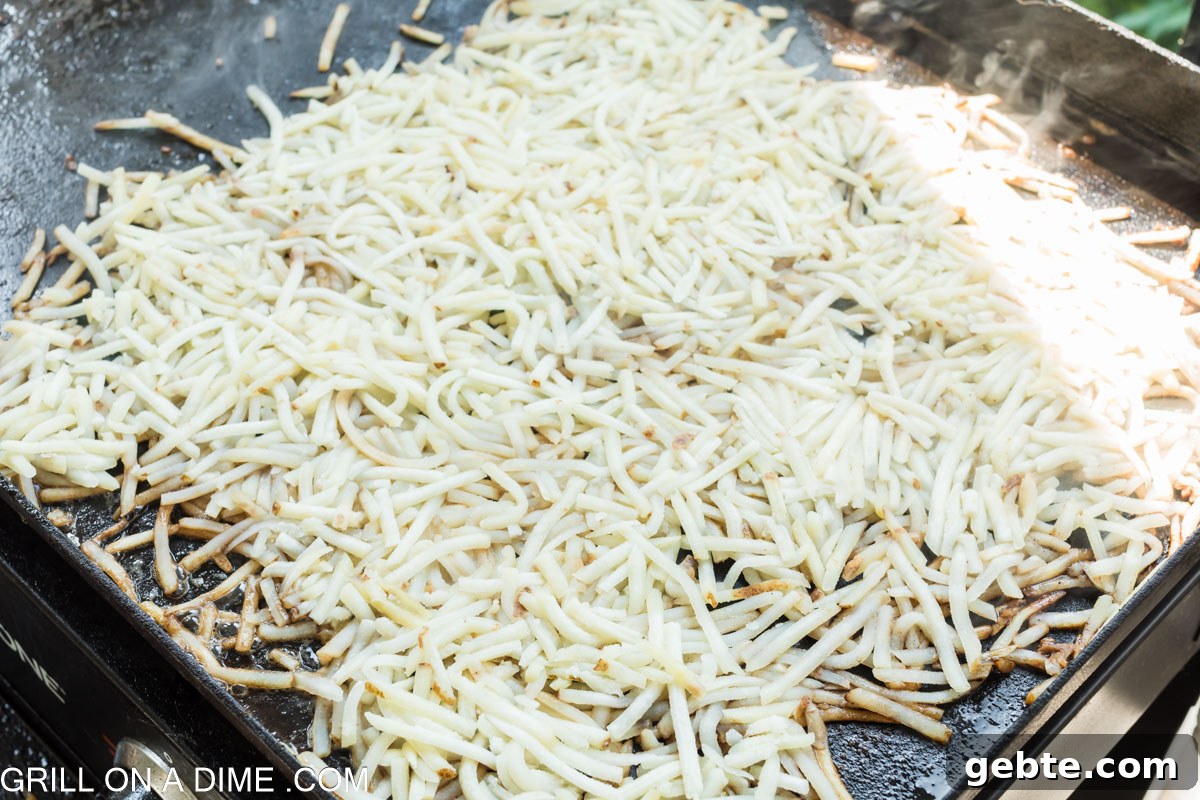 Spreading shredded hashbrowns on griddle