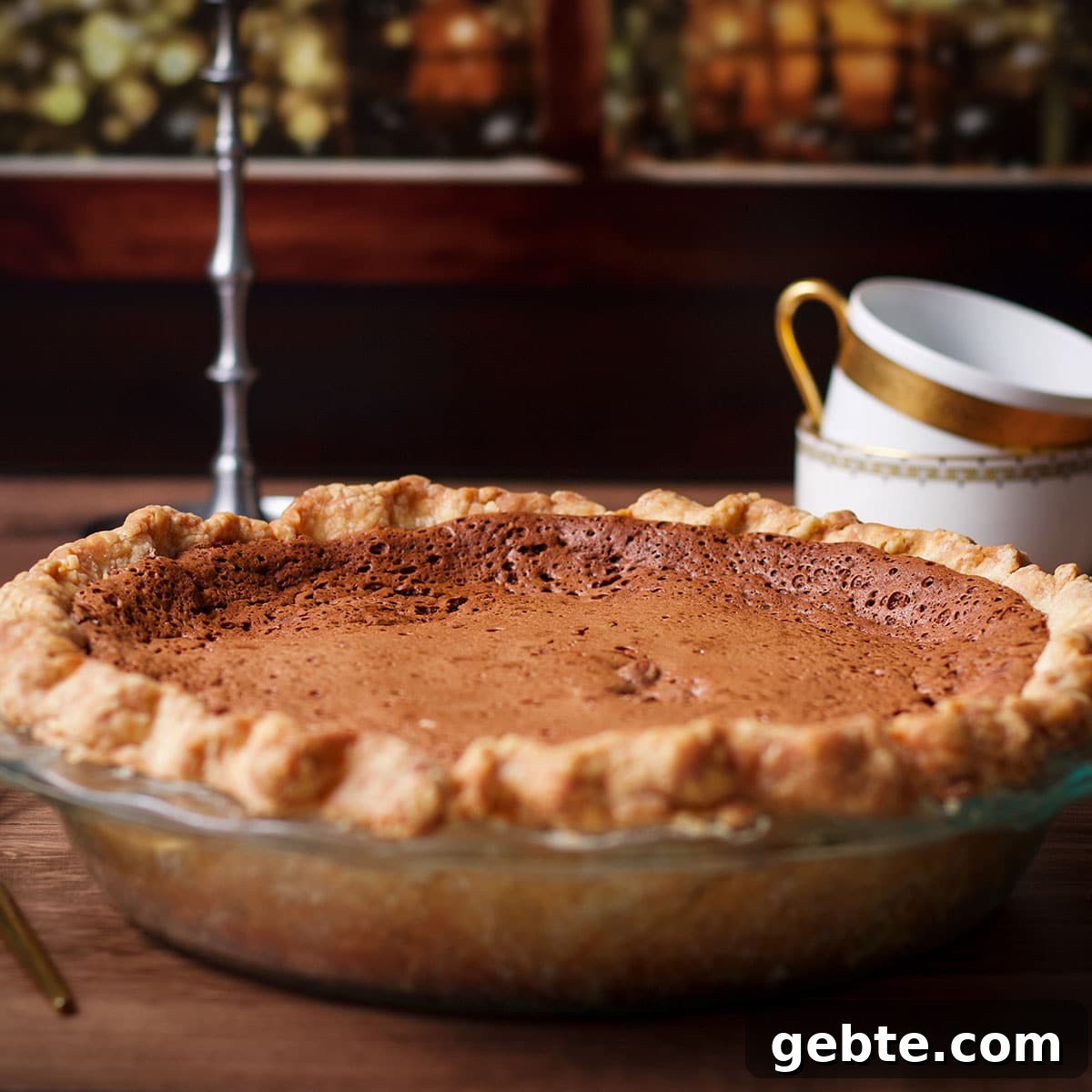 Decadent Chocolate Almond Pie Recipe — Crispy Crust & Rich Filling 11 A freshly baked chocolate almond pie cooling on a countertop next to a window.