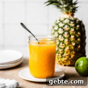A mason jar of golden yellow jam.