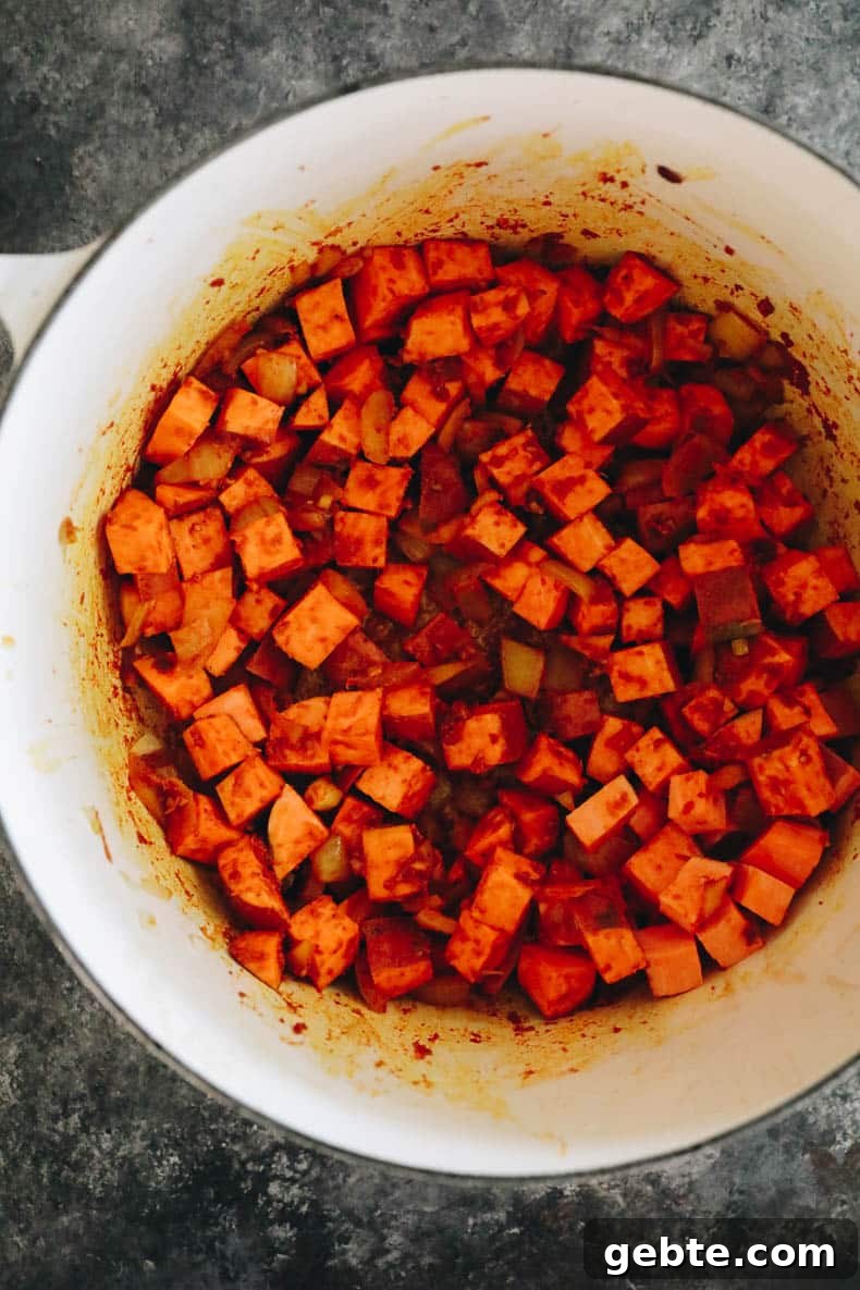 Creamy Curried Sweet Potato Soup Recipe for Cozy Dinners 3 Cubed sweet potato in a stock pot.