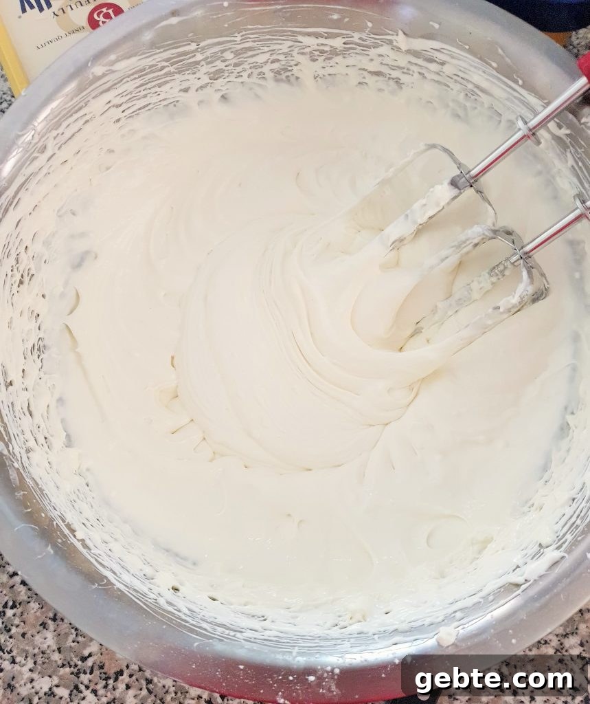 Nutella Cookies and Cream Cheesecake Recipe 11 Cheesecake mixture in a stainless steel bowl.