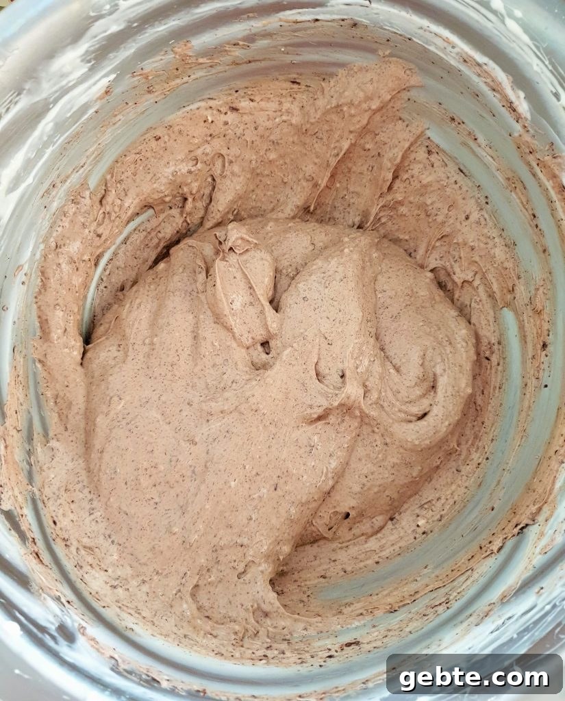 Nutella Cookies and Cream Cheesecake Recipe 13 Chocolate cheesecake mixture in stainless steal bowl.
