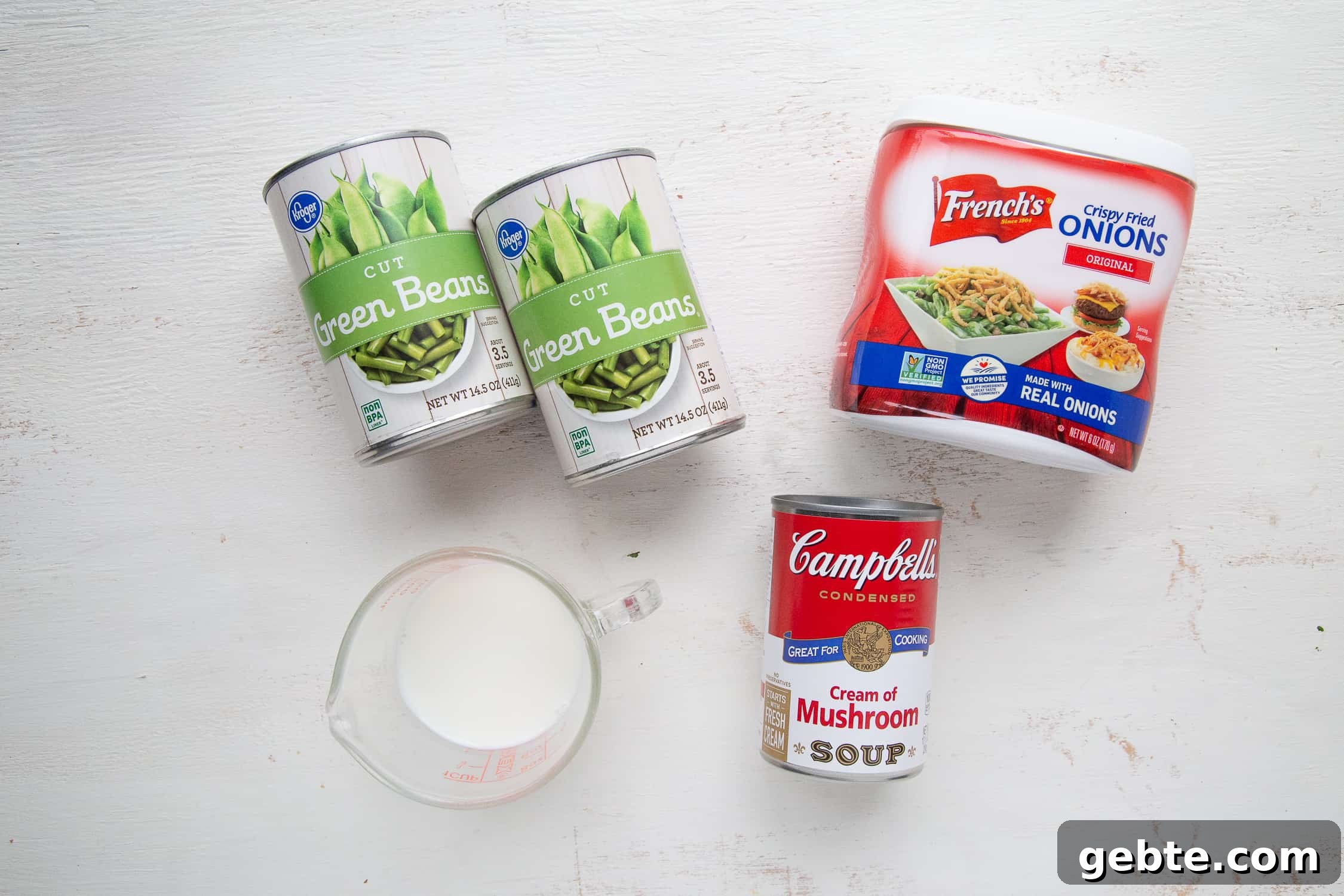ingredients for green bean casserole on a white table.