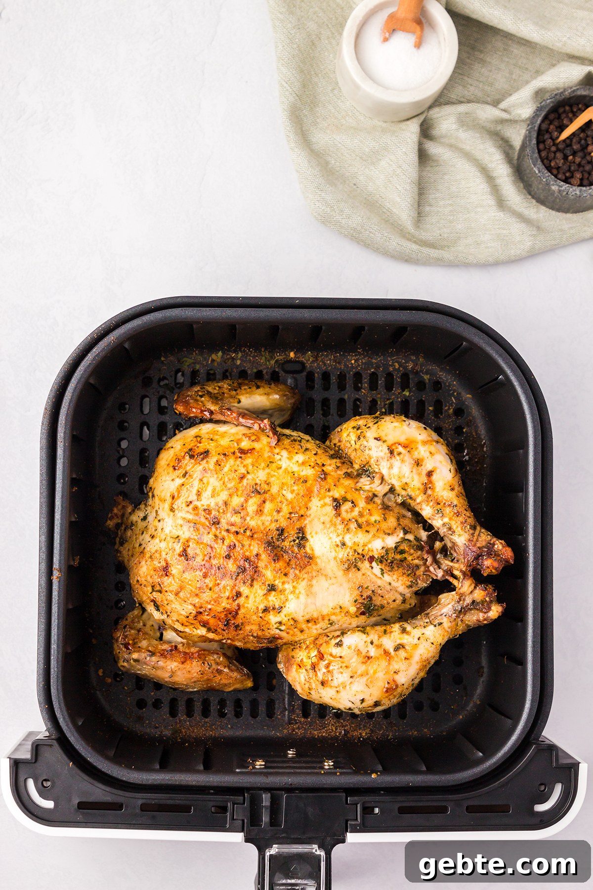 Whole Chicken turned breast side up in air fryer to finish cooking.