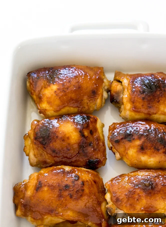 Crispy Honey Mustard Baked Chicken Thighs 3 Top down 6 crispy honey baked chicken thighs in a white baking dish.