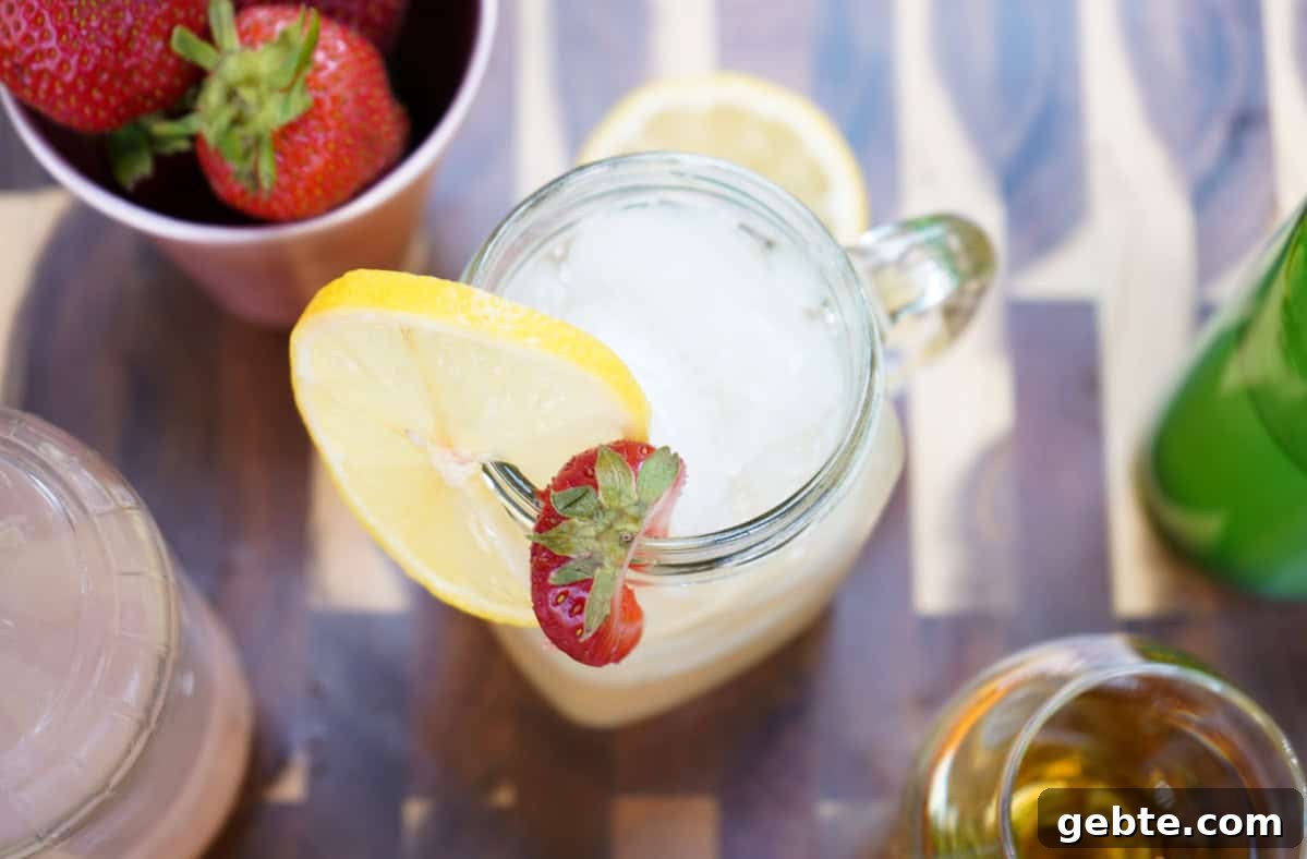 Strawberry Lemonade Kentucky Mule Cocktail 3 Kentucky mule in glass with lemon and strawberries.