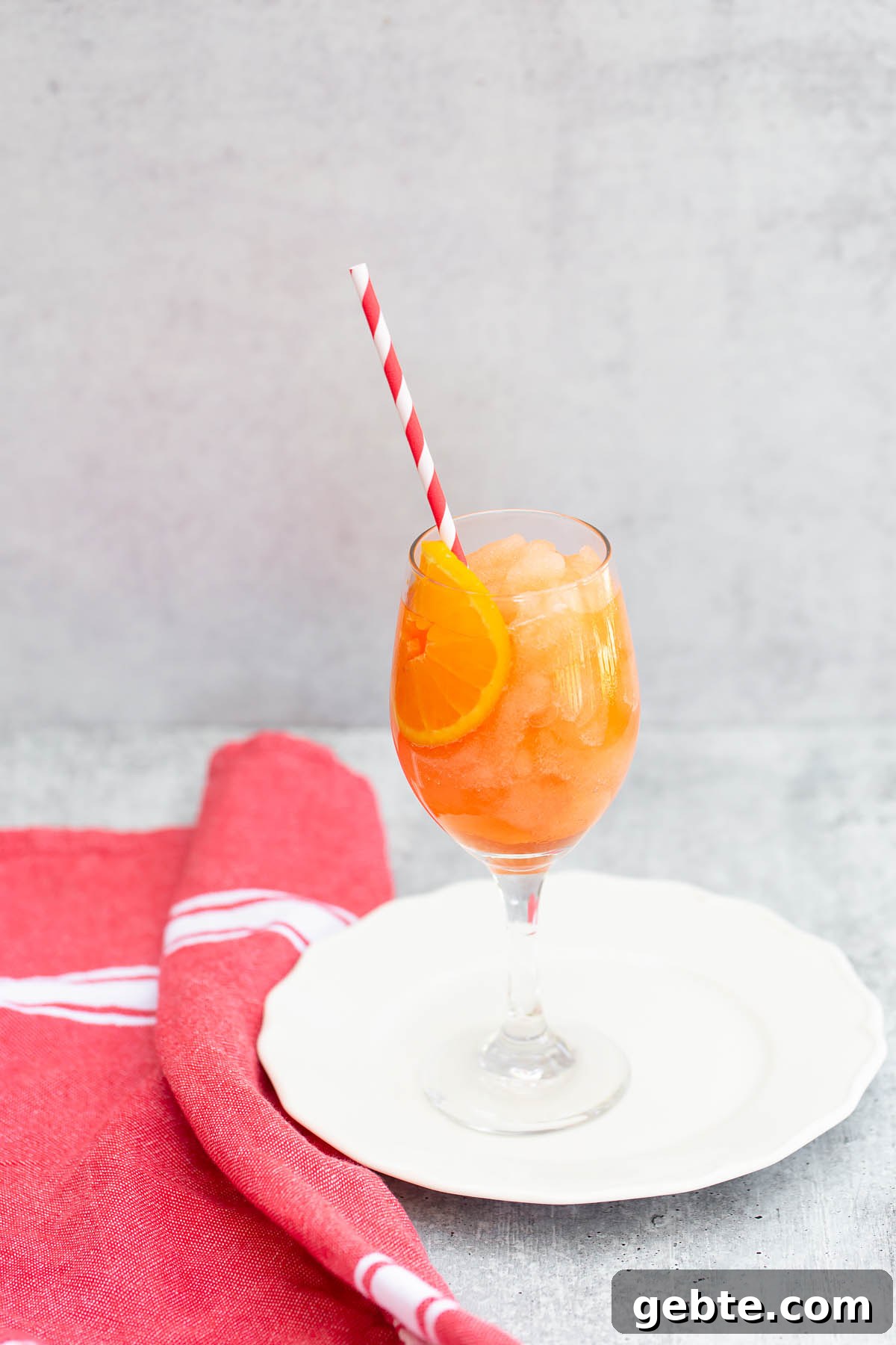 frozen aperol spritz with a straw