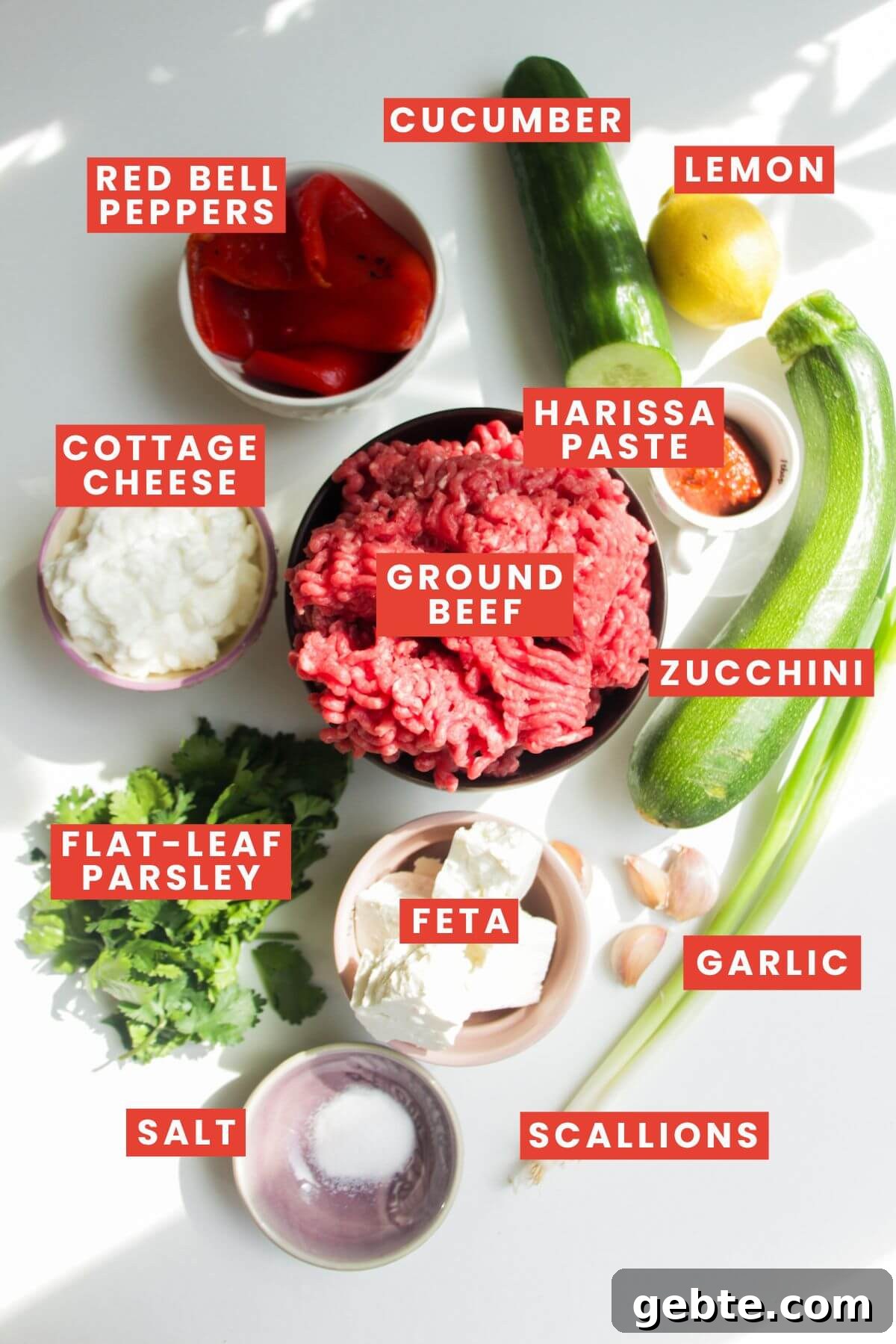 Ingredients for harissa, feta & zucchini meatballs laid out and labelled.