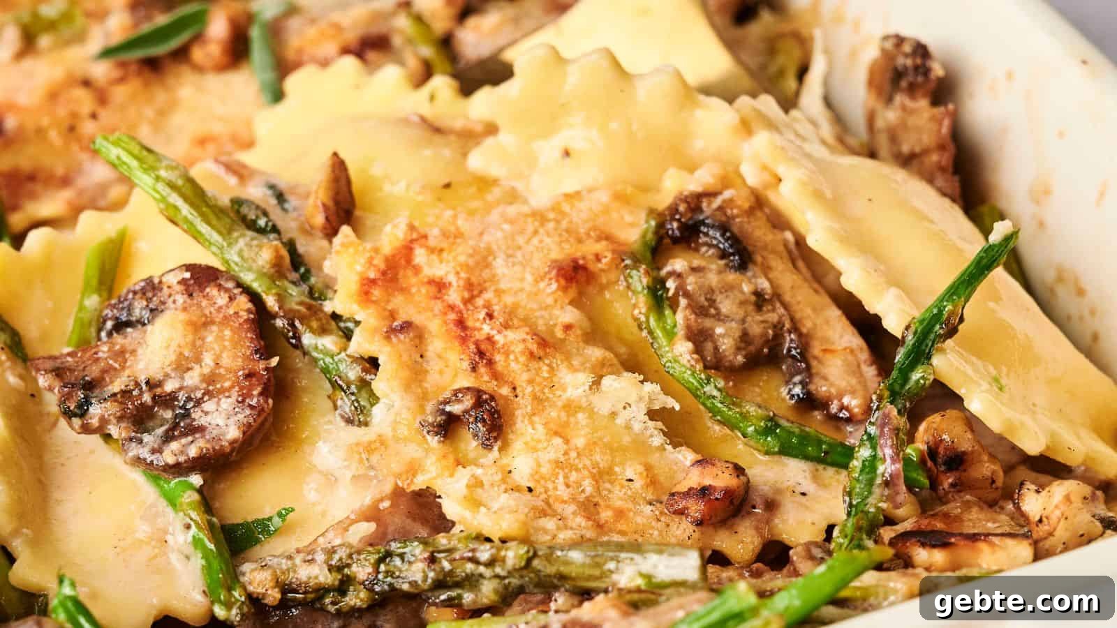 Close-up of a baked dish with ravioli, mushrooms, asparagus, and melted cheese on top.