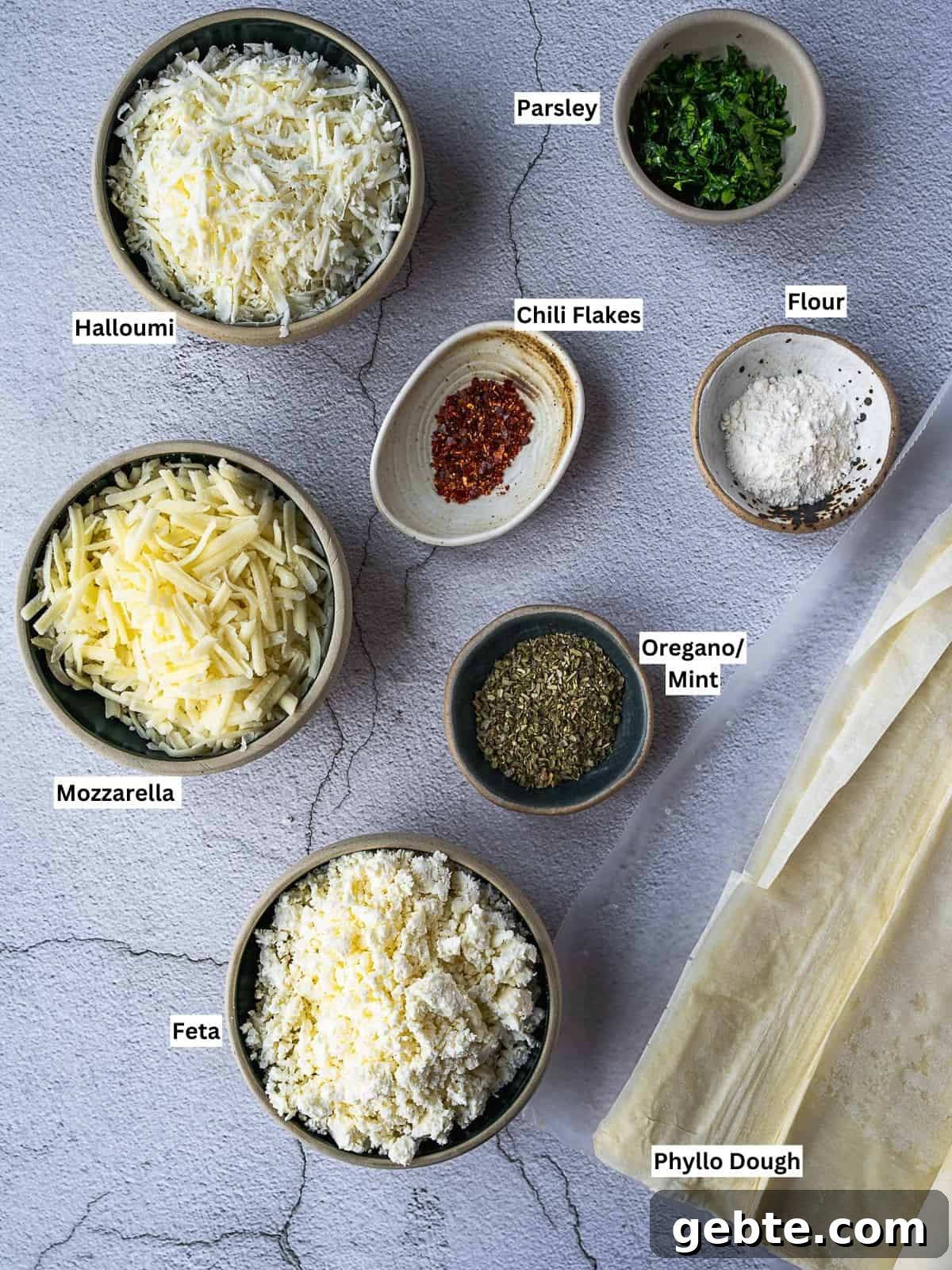 Crispy Cheese Sambousek: Middle Eastern Fried Pastries 3 Recipe ingredients laid out on a board.