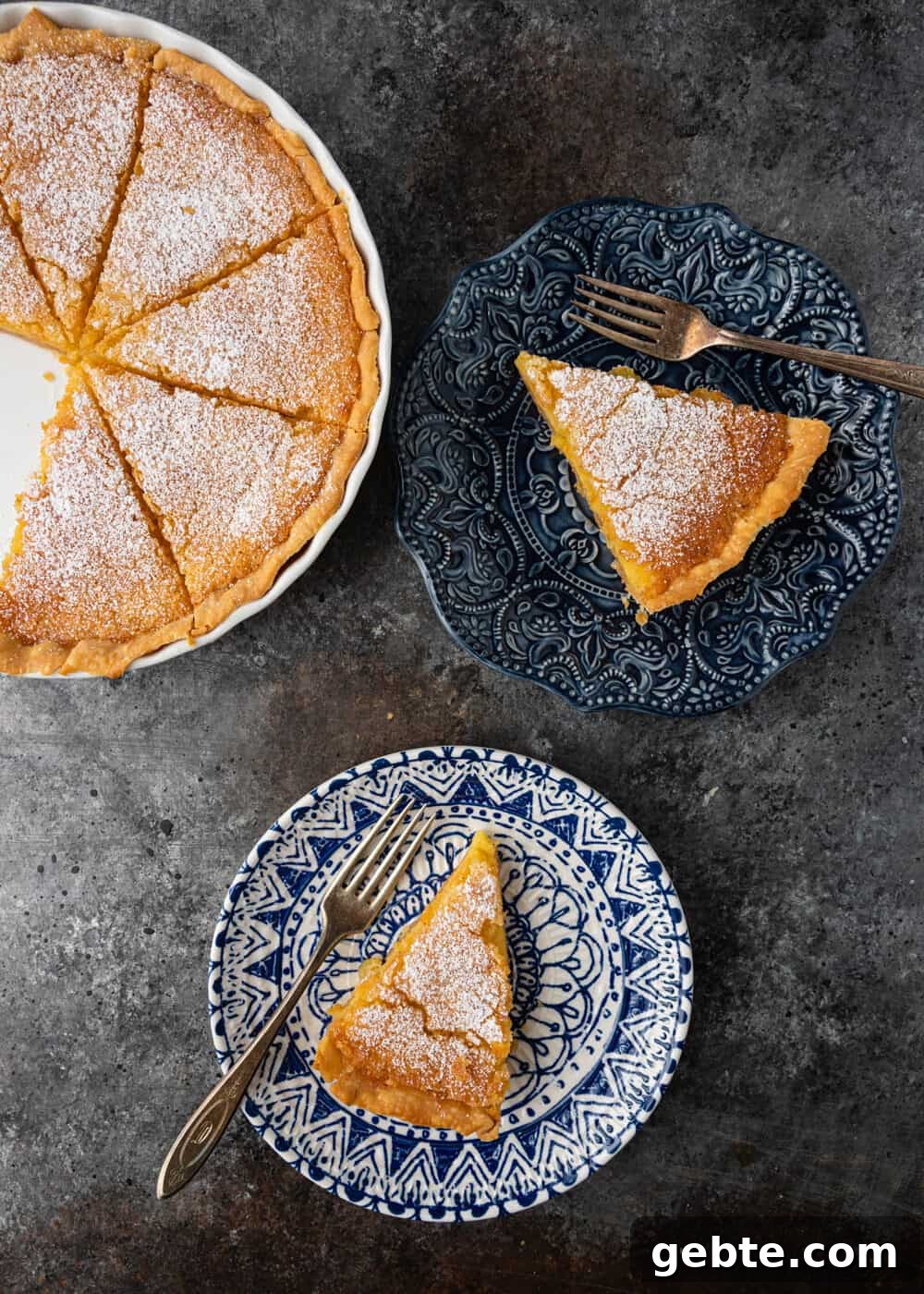 Lazy Mary's Meyer Lemon Tart Recipe 3 overhead: 2 slices of meyer lemon tart on plates with forks